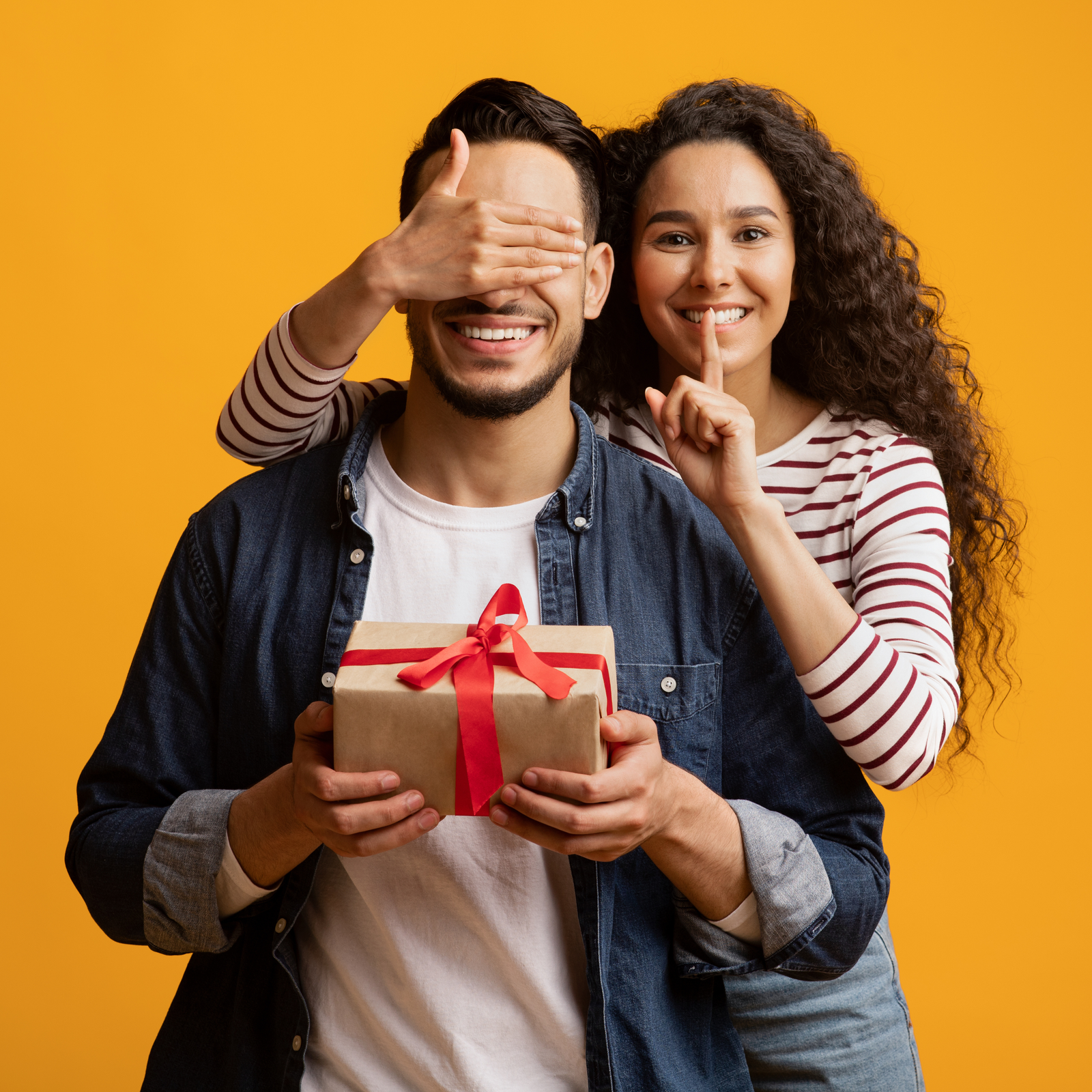 A man happily opening a gift box